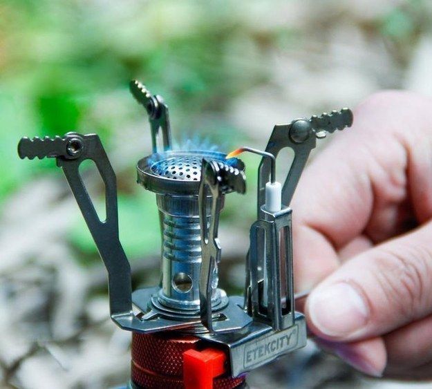 a person is holding an open lighter in their left hand, with the lighter attached to it