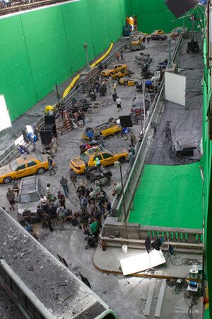 an overhead view of a construction site with cars and trucks on the ground in front of a green screen