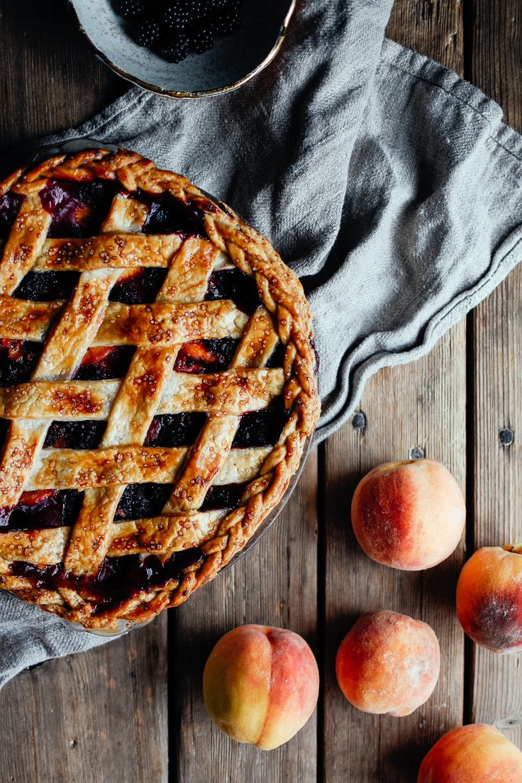 fresh peaches and a pie on a wooden table