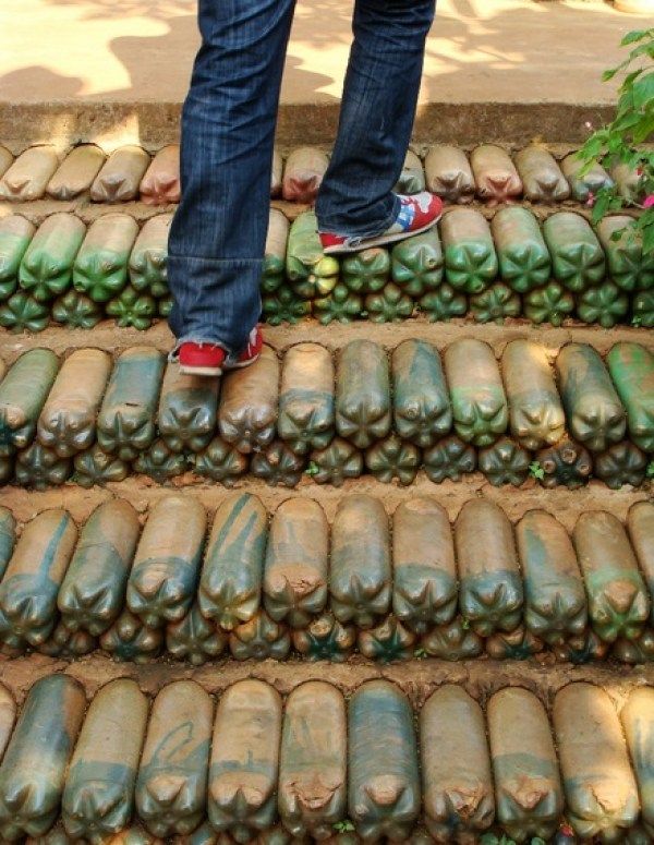 a person standing on some steps made out of bottles