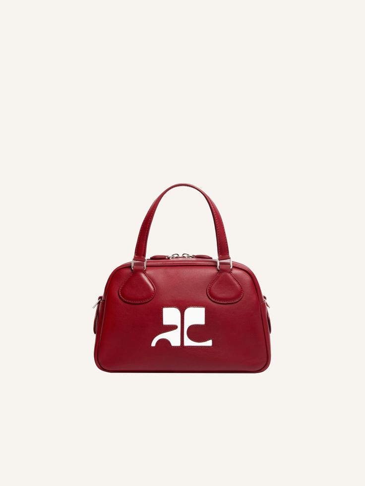 Iconic leather Bowling bag with AC logo inlaid on front. Metal zipper closure. Short handles with removable and adjustable shoulder strap. Inside zipped pocket. Length: 25 cm Height: 15.5 cm Width: 12 cm Formal Double Handle Shoulder Bag With Logo, Leather Satchel With Logo And Top Handle, Leather Top Handle Satchel With Logo, Double Handle Shoulder Bag With Engraved Logo, Luxury Logo Satchel Crossbody, Business Bags With Logo And Double Handle, Designer Top Handle Satchel With Logo, Double Handle Bags With Engraved Logo, Formal Top Handle Bag With Logo