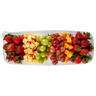 a platter filled with lots of different types of fruits and cheese on top of each other