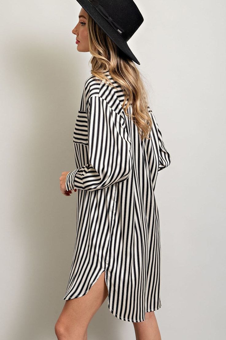 Stripe printed button down shirt dress featuring a collared neckline, one chest pocket, a high-low design, buttoned cuffs, two side slits, and a pleat in the back for added detail. Measurements: Bust: small 46", medium 48", large 50" Front Length: small 35", medium 36", large 37" Back length: small 37", medium 38", large 39" Trendy Oversized Button-up Shirt Dress, Oversized Collared Dress For Day Out, Spring Oversized Button-up Midi Dress, Oversized Button-up Midi Dress For Spring, Long Sleeve Shirt Dress With Striped Collar For Work, Oversized Spring Midi Dress With Button-up, Oversized Button-up Dress For Day Out, Fall Daywear Shirt Dress With Cuffed Sleeves, Chic Shirt Dress With Cuffed Sleeves For Fall