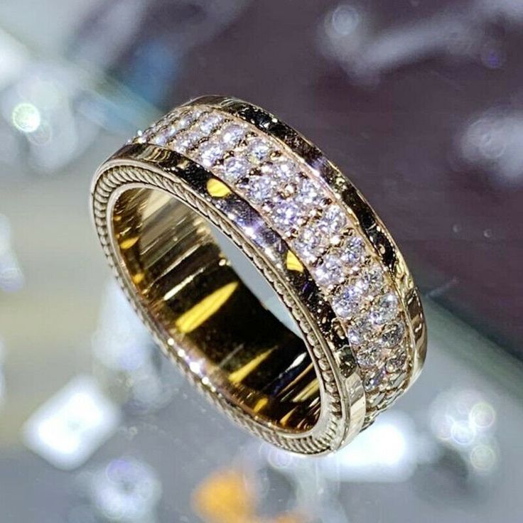 a gold ring with rows of diamonds on it