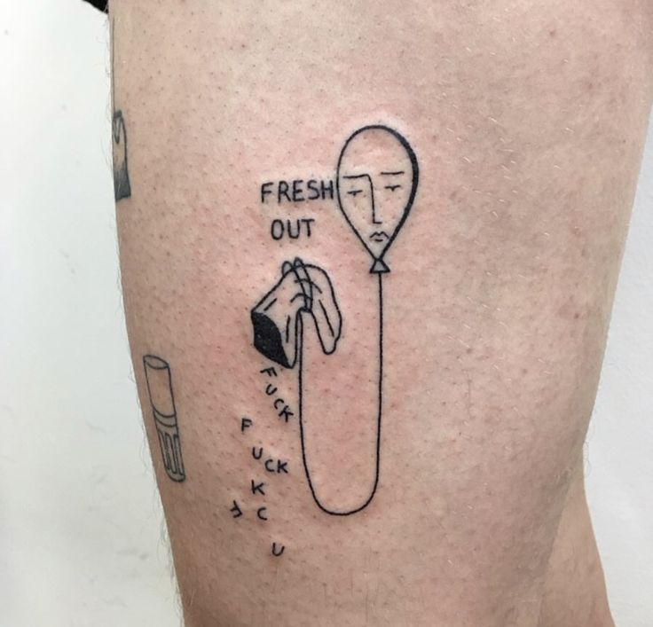 a person with a tattoo on their leg that says fresh out and hot air balloon