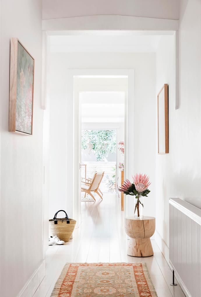 the hallway is clean and ready to be used as a place for flowers in vases