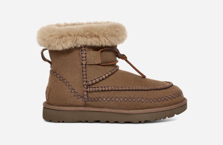 Please join us in welcoming the newest addition to our Classic family: the Classic Mini Alpine. Steeped in UGG® Heritage, this boot features iconic details like our signature Twin Seam, exposed sheepskin collar, and fixed leather lace. The suede upper and ultralight on-the-foot feel deliver the familiar UGG® experience you know, love, and crave. | Suede upper. Decorative stitching, UGG®braid pull tab, Suede mudguard. Fixed leather lace. 17mm Sheepskin collar lining, 17mm UGG®plush 60% upcycled w Ugg Mini, Decorative Stitching, Classic Boots, Classic Mini, Real Fur, Leather Lace, Pull Tab, Womens Uggs, Leather And Lace