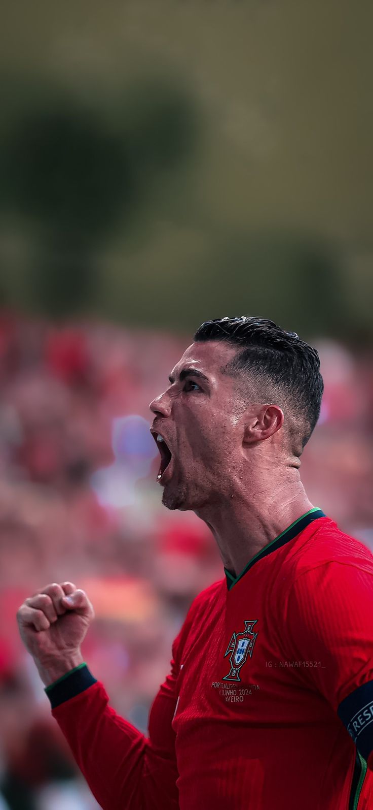 a man with his mouth open in front of an audience at a soccer game,