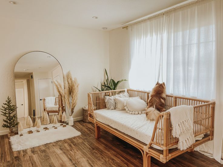 a dog sitting on top of a bed next to a wooden floor in a room