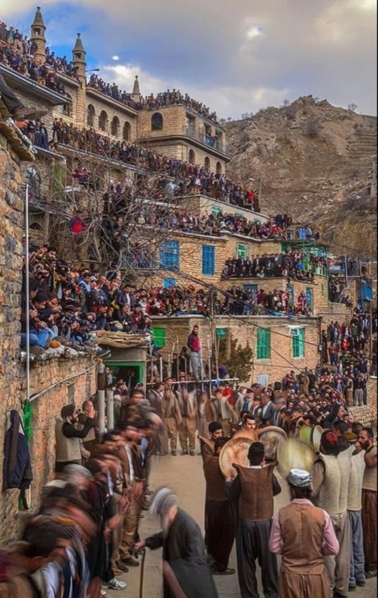 a crowd of people standing on the side of a road