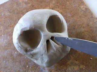 a human skull being cut with a knife