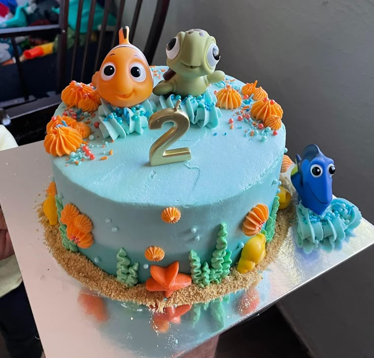 there is a blue cake with two fish on it