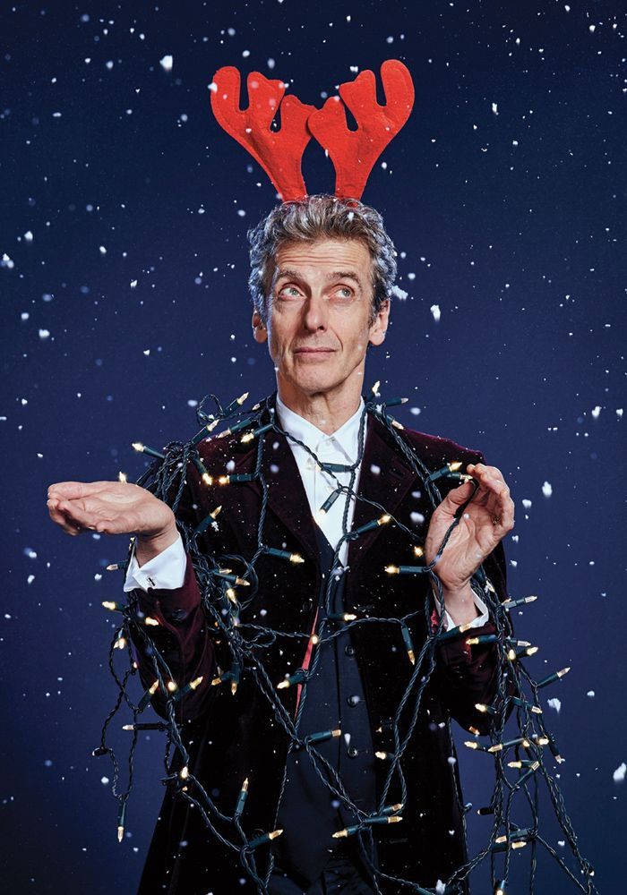 the doctor who is wearing reindeer antlers on his head and holding out his hands