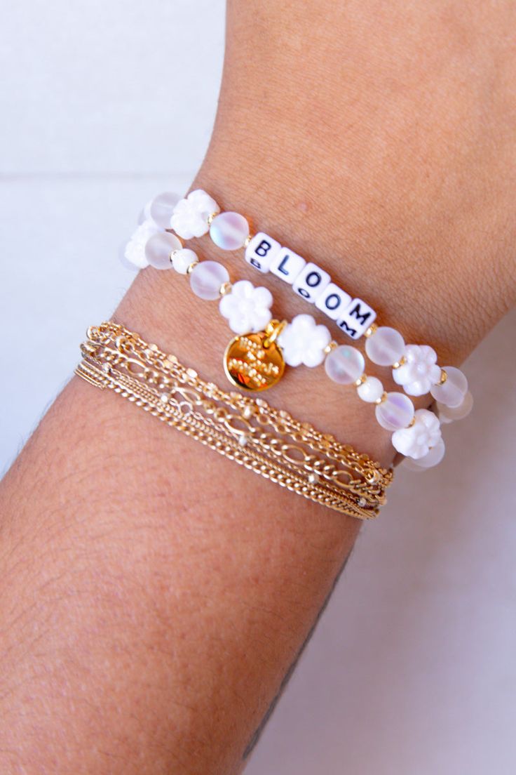 Embrace your personal growth and flourish with our "Bloom" bracelet from Little Words Project. This delicately crafted piece symbolizes new beginnings and the beauty of blooming where you are planted. Perfect for inspiring daily positivity and strength, it features elegant flower beads and a reminder to thrive in all aspects of life. Whether you're treating yourself or gifting a loved one, the "Bloom" bracelet is a chic reminder to keep growing and shining. Celebrate your journey with this beaut Delicate White Adjustable Jewelry, Everyday White Flower Jewelry, Inspirational White Bracelets For Friendship, Inspirational White Jewelry For Gifts, Inspirational White Jewelry Gift, Delicate White Bracelets For Spring, White Delicate Bracelet For Spring, Delicate White Bracelet For Spring, Delicate White Jewelry For Spring