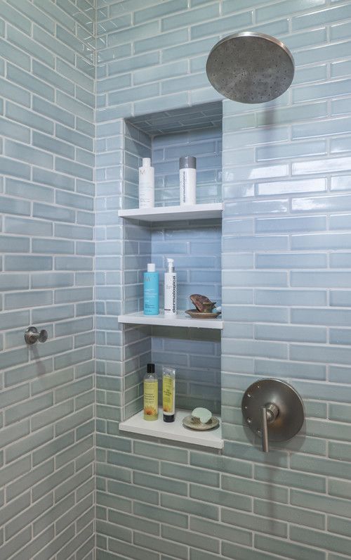 a shower with shelves and soaps in it