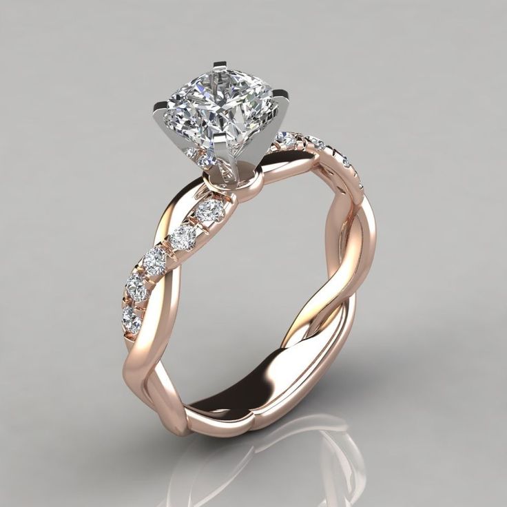 an engagement ring with a twisted band and a diamond center stone in the middle, on a gray background