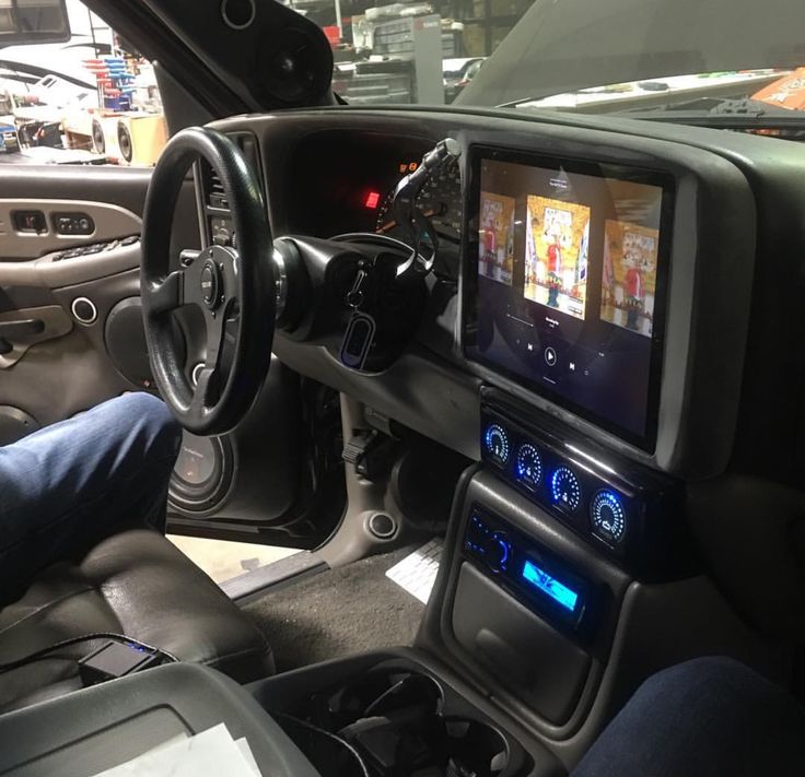 the interior of a car with an entertainment system on it's dash board and steering wheel