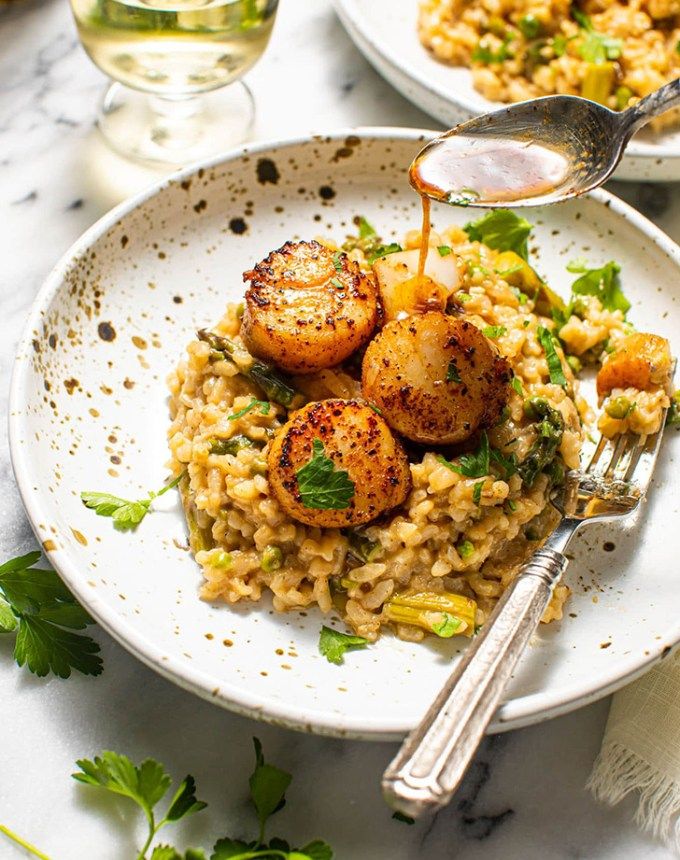 a plate with rice and scallops on it