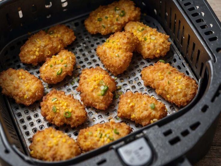 some fried food in a black basket on a table