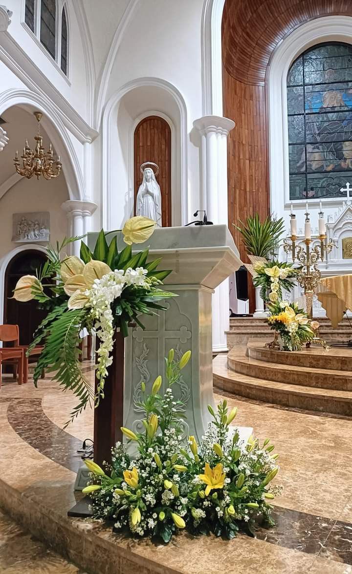 flowers are placed in front of the alter