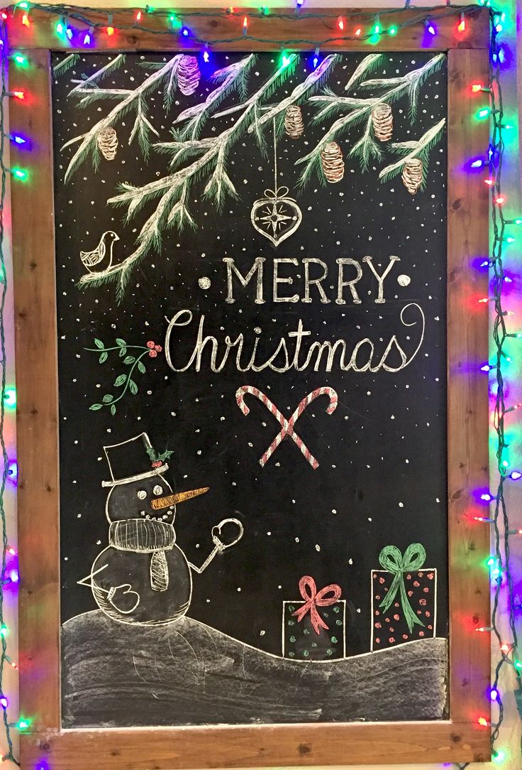 a chalkboard with christmas writing on it