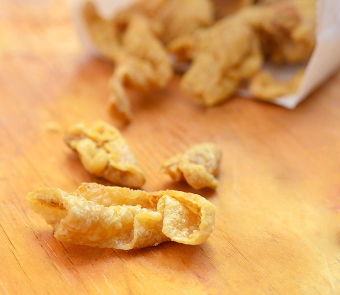 some food that is laying on a wooden table with it's peels out