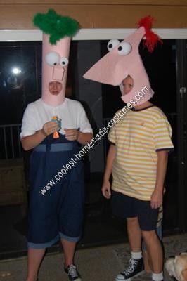 two men in costumes standing next to each other with their heads made out of paper