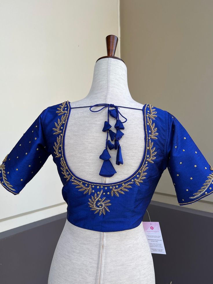 Royal Blue Color Raw Silk Readymade Blouse with beautiful Handwork Work in beads and Zircon. Item : Readymade BlouseReady-to-Wear : YesSize : 36 (Can be opened to Size 40)Color : Royal Blue Blouse Fabric : Soft Silk Lining : Yes, it is fully lined Padded or Non-Padded : PaddedClosure: Front Closure with hooks.Disclaimer - : -This is a Standard Size blouse. We do not guarantee perfect fit as every body and shape is different. Little or no alteration would be required to get the perfect fit. - Col Blouse Hangings, Blouse Handwork, Royal Blue Blouse, Padded Blouse, Color Blouse, Readymade Saree, Saree Blouses, Nehru Jackets, Readymade Blouse