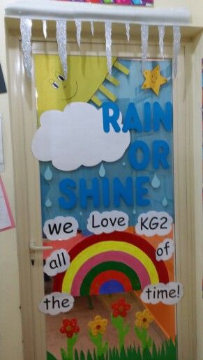 a bulletin board with rain, rainbows and clouds hanging from it's sides