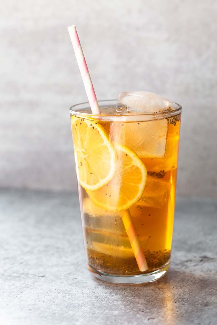 a glass filled with ice and lemon slices