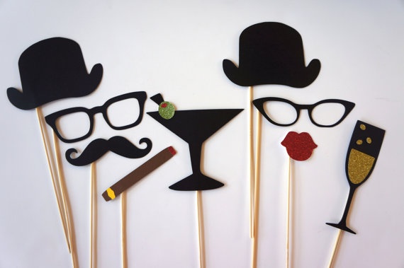 the photo props are made to look like glasses, hats, mustaches and lips