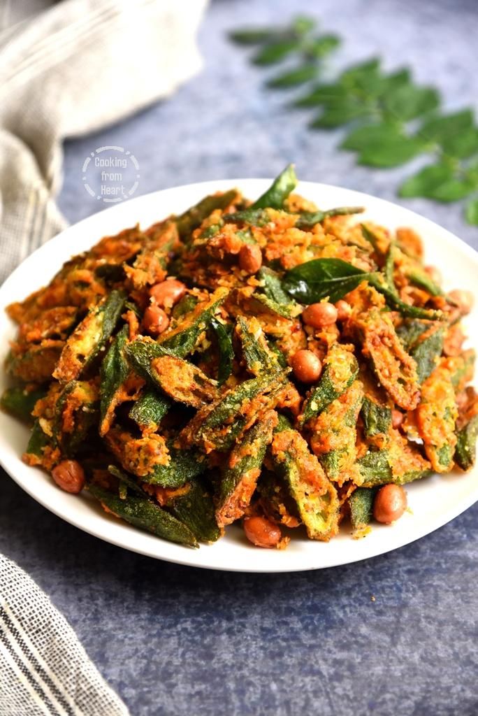 a white plate filled with food on top of a blue table cloth next to green leaves