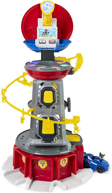 a toy tower with cars and toys around it on a white background in front of a blue car