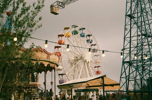 an amusement park with ferris wheel and lights