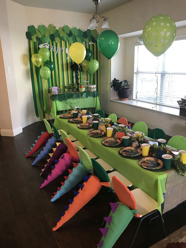 a table set up for a party with balloons