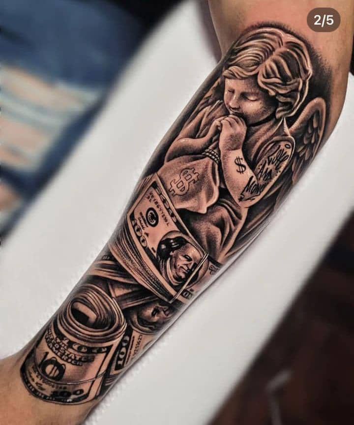 a man's arm with money and angel tattoos on it