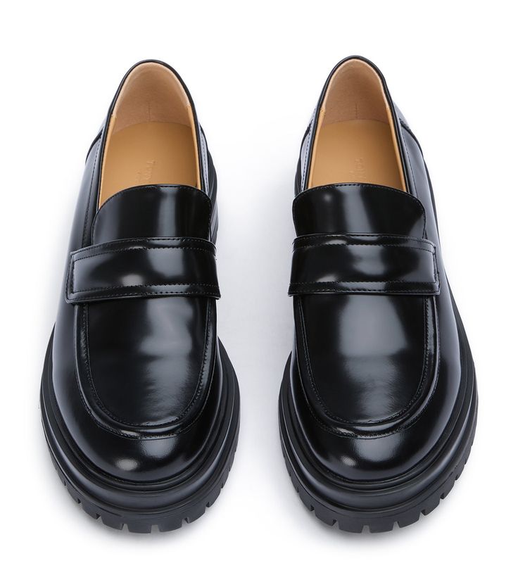 Stand-out from the crowd with our Wiz loafer. Showcasing a shiny black leather exterior, this design features an exaggerated chunky sole with a sleek rounded toe-shape, a high-cut vamp and is finished with a leather upper, lining and cushioned foot-bed. -Material: Leather Upper & Lining -Sole: Man-Made -Fit: We recommend choosing a half size down -Toe-shape: Rounded -Features: Chunky sole -Heel: 4.5cm Black Formal Platform Loafers With Lug Sole, Black Platform Loafers With Lug Sole For Formal Wear, Black Platform Loafers With Lug Sole For Formal Occasions, Modern Black Platform Loafers For Work, Business Patent Leather Platform Loafers With Rubber Sole, Business Platform Loafers With Rubber Sole In Patent Leather, Modern Black Platform Loafers For Business, Modern Black Platform Loafers For Office, Black Loafers With Vibram Sole For Work