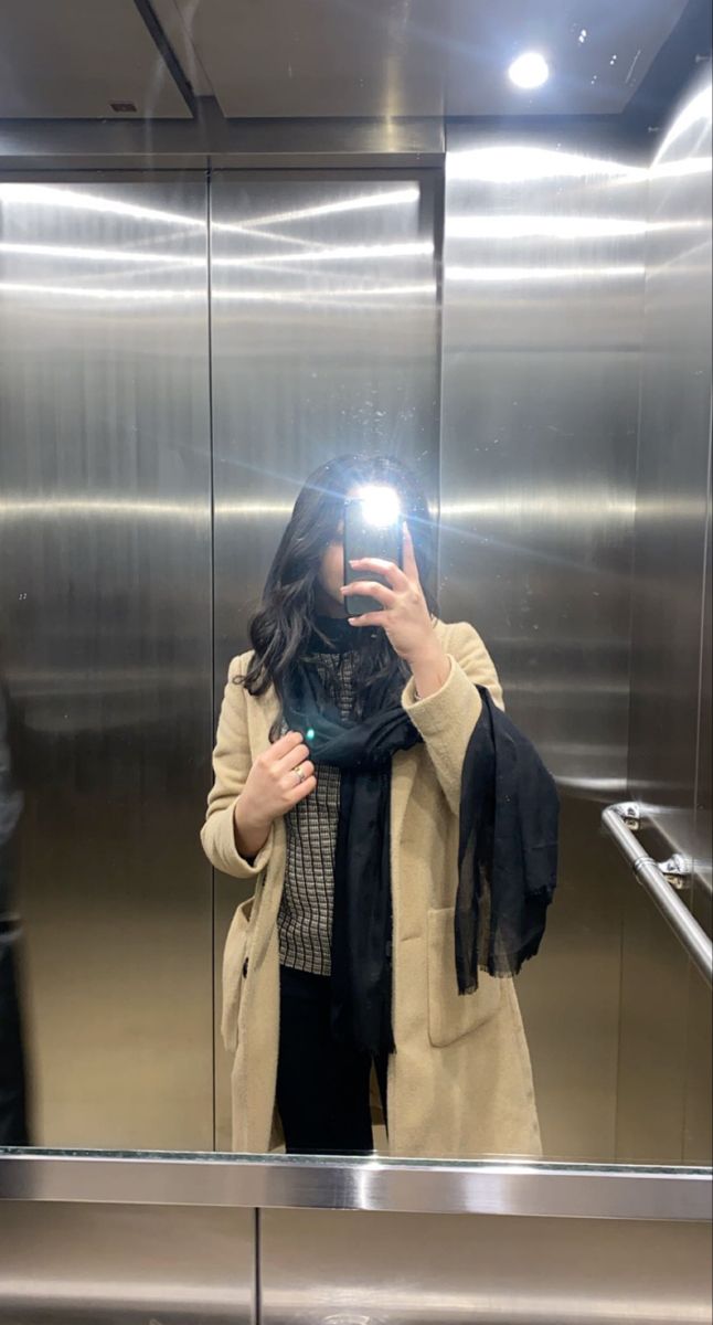 a woman taking a selfie in an elevator