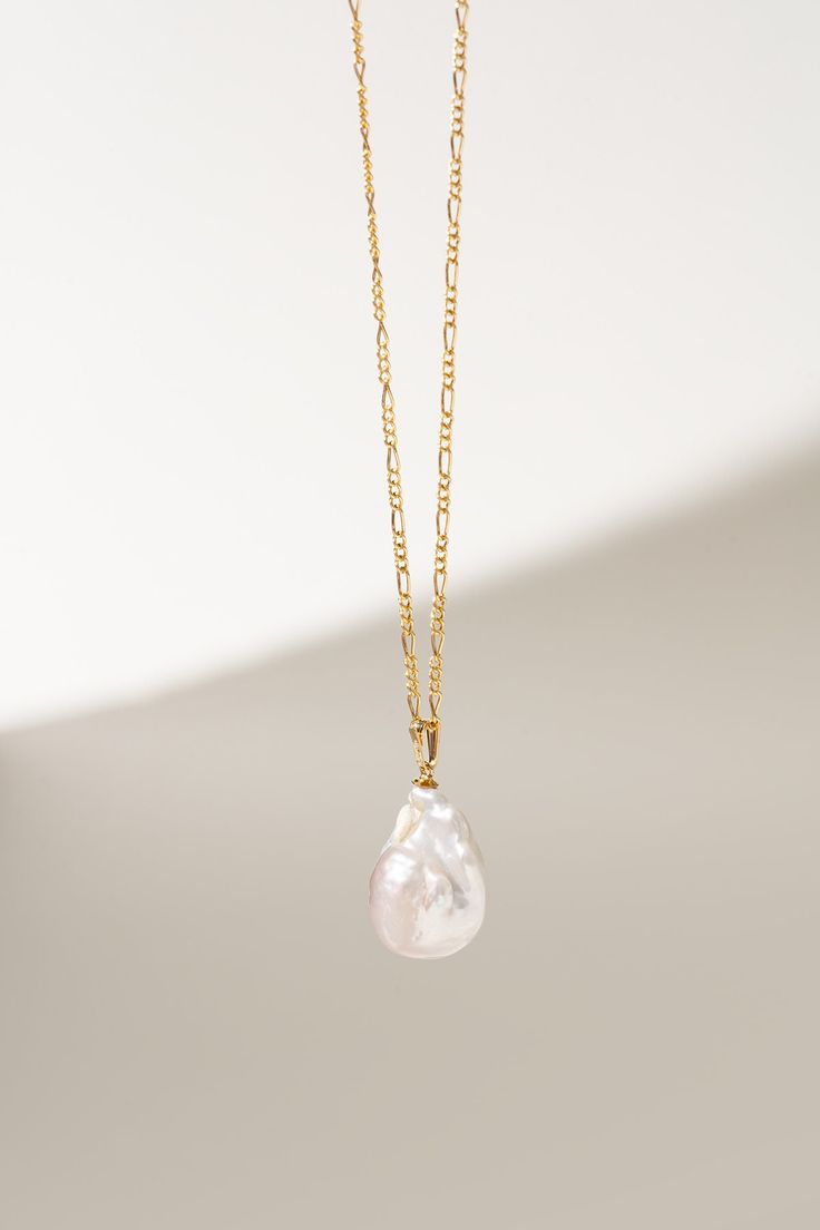 Discover the elegance of our Baroque Pearl Necklace, featuring a stunning Figaro chain that exudes timeless sophistication. This exquisite piece is perfect for bridesmaid gifts, blending the unique charm of baroque pearls with the classic allure of a gold-filled Figaro chain. Ideal for weddings and special occasions, this necklace adds a touch of luxury and style, making it a cherished keepsake for your bridal party.  * 14k Gold filled figaro chain * Chain length: 20" * Baroque Pearl pendant * W Violet Necklace, Timeless Necklace, Hypoallergenic Necklace, Baroque Pearl Necklace, Gold Filled Chain, Unique Charms, Baroque Pearls, Gift Wedding, 14kt Gold