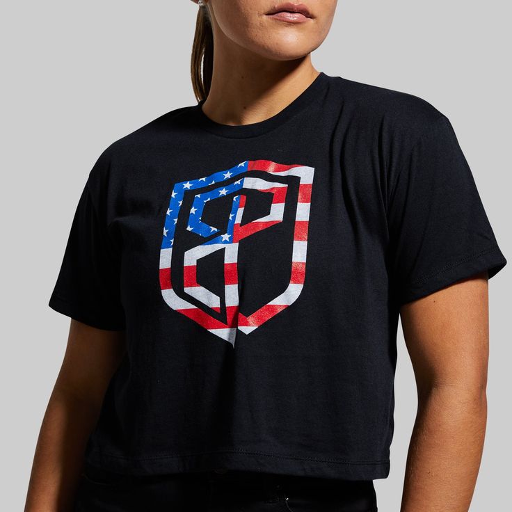 Made from a soft, performance-stretch fabric that gives you plenty of room to move while working out or lifting, our USA Crop Tee complements any outfit you put together. With an American Flag Born Primitive Logo, it’s the perfect go-to option for Memorial Day, 4th of July, or any other day of the year to rep your support for our country. Graphic Tops, Crop Tee, Perfect Shirt, Black Media, Black Tee, Memorial Day, American Flag, Stretch Fabric, ? Logo