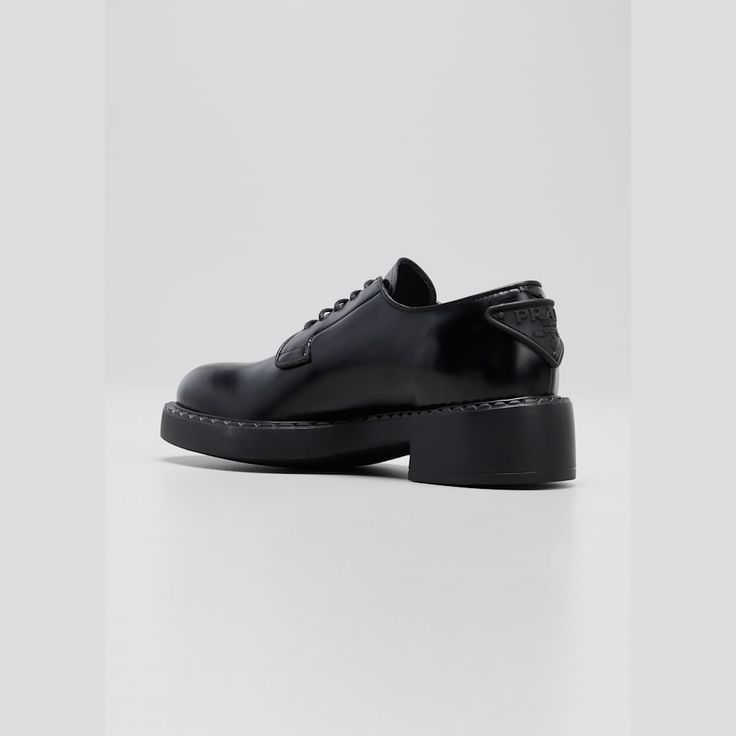 Prada derby loafers in calf leather 2.00 in / 50 mm flatform heel Almond toe Lace-up vamp Logo triangle at back  Leather/rubber outsole Made in Italy Designer Brogue Lace-up Shoes For Workwear, Designer Lace-up Shoes With Brogue Detailing For Work, Luxury Patent Leather Lace-up Shoes For Work, Elegant Slip-on Oxfords With Contrast Sole, Luxury Leather Shoes With Brogue Detailing And Flat Heel, Designer Lace-up Shoes With Brogue Detailing, Elegant Low-top Calf Leather Shoes, Low-top Calf Leather Oxfords For Work, Luxury Plain Toe Lace-up Shoes For Work