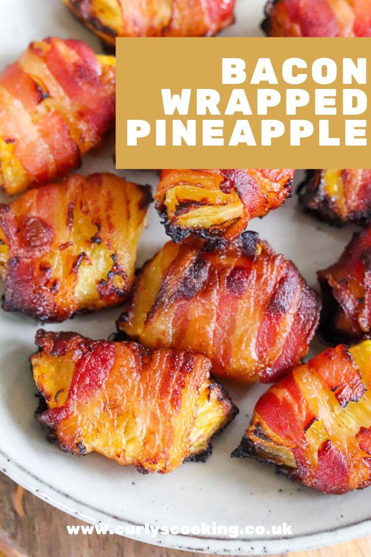 bacon wrapped pineapples on a white plate with the title overlay reads bacon wrapped pineapples