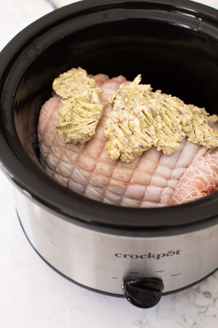 an open crockpot with some meat in it