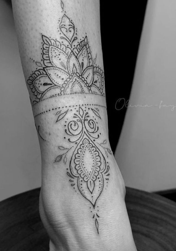 a woman's foot with a tattoo on it