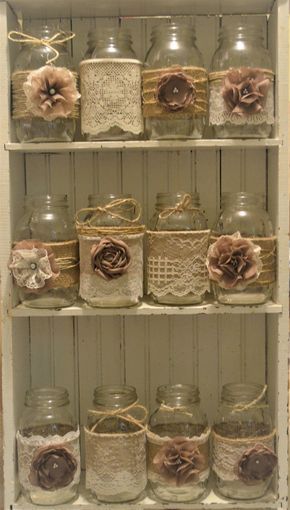 the shelves are filled with glass jars and lace