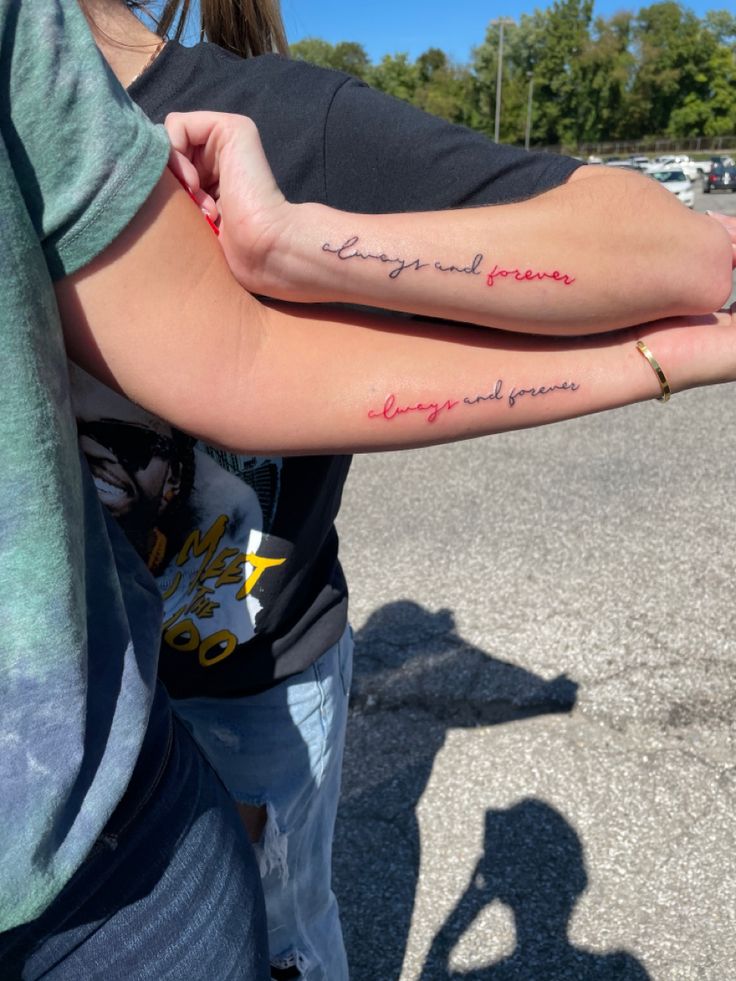 two people with tattoos on their arms holding each other's hands in the parking lot