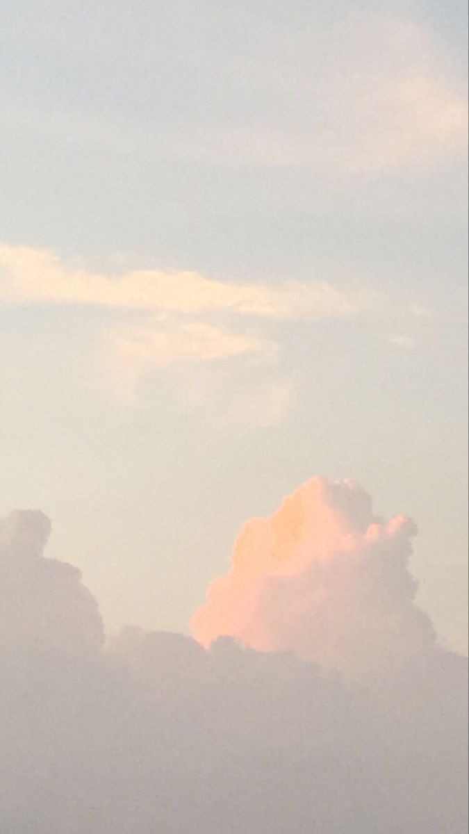 two airplanes flying in the sky with clouds