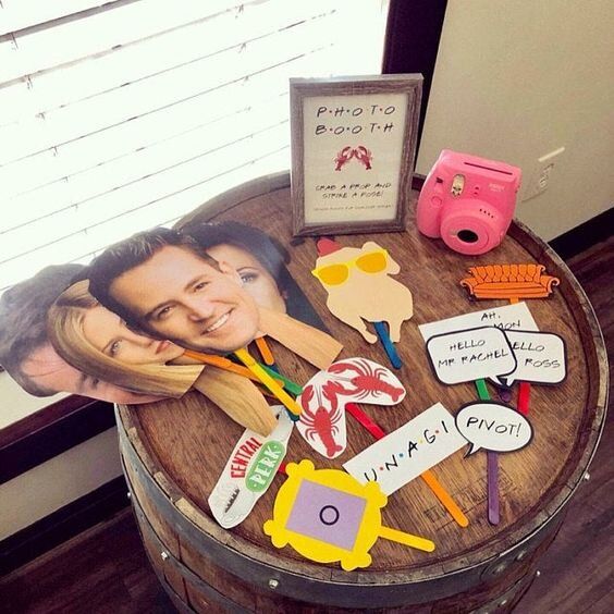 a wooden barrel table topped with lots of personalized items and a photo on it