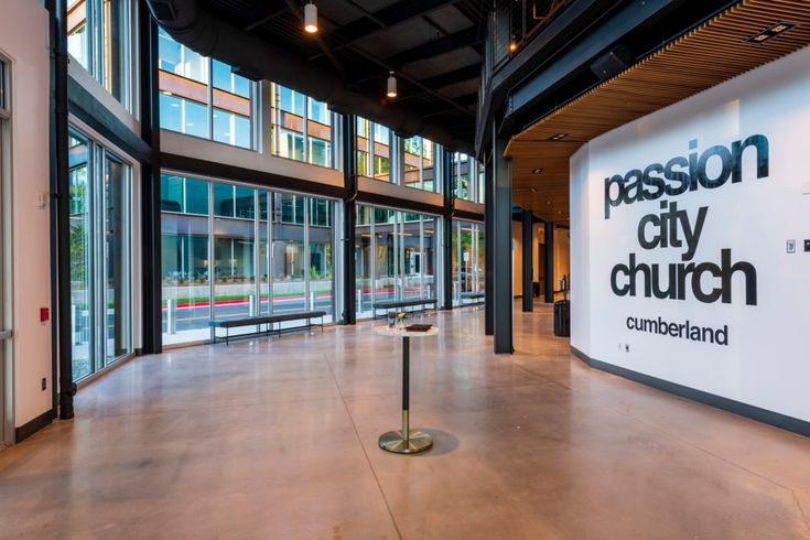 the inside of a building with large windows and a sign that says passion city church