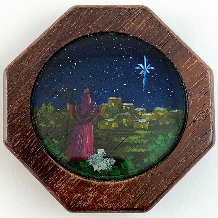 a wooden frame with an image of a person holding a star in the night sky